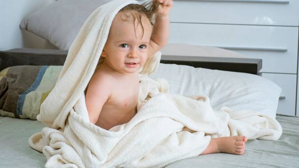 Funny toddler boy in big white towel after bathing - Photo, Image