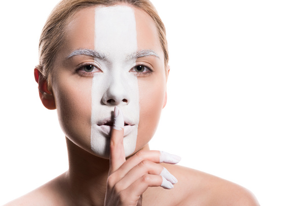 beautiful woman with white paint on face showing silence sign isolated on white - Foto, immagini