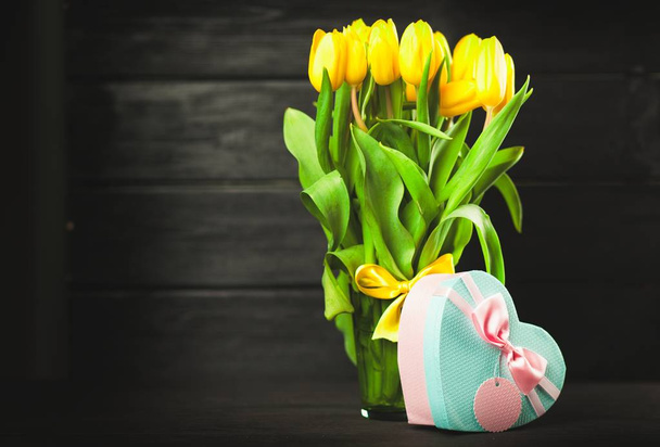 Yellow tulips on wooden background - Fotó, kép