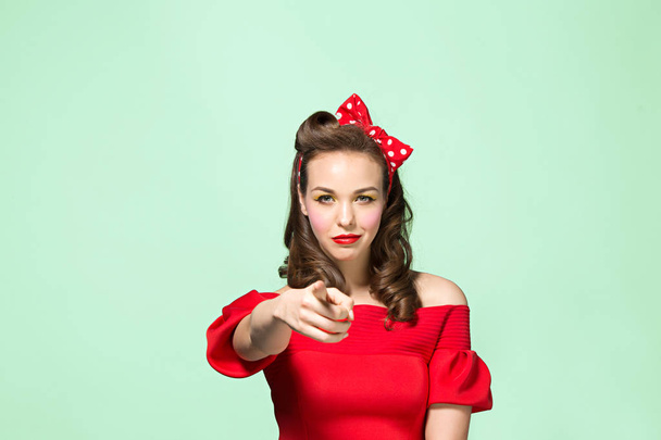 Beautiful young woman with pinup make-up and hairstyle. Studio shot on white background - 写真・画像