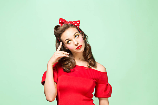 Beautiful young woman with pinup make-up and hairstyle. Studio shot on white background - Foto, immagini