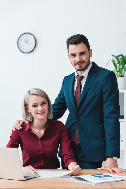 beautiful young business people smiling at camera while working together in office - Fotoğraf, Görsel