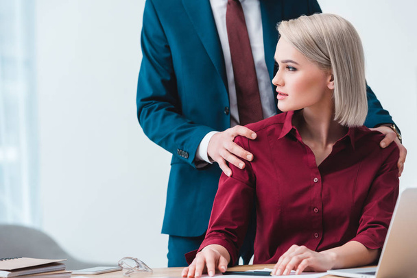 cropped shot of businessman flirting with beautiful young female colleague in office - Photo, Image