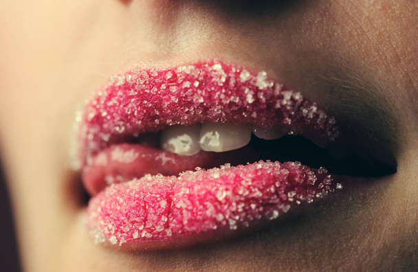 emotional sexy girl with a lollipop over pink background in studio - Fotografie, Obrázek