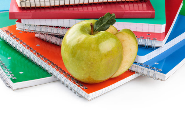 Notebooks and green apple. - Photo, Image