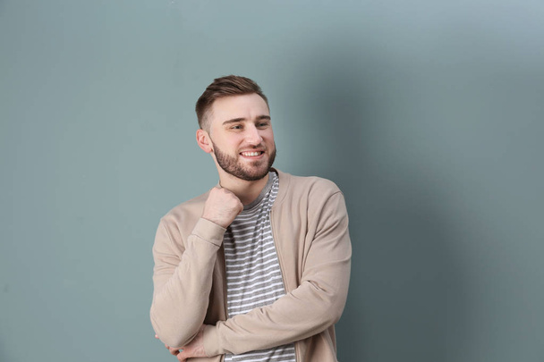 Portrait of confident young man on color background - Photo, image