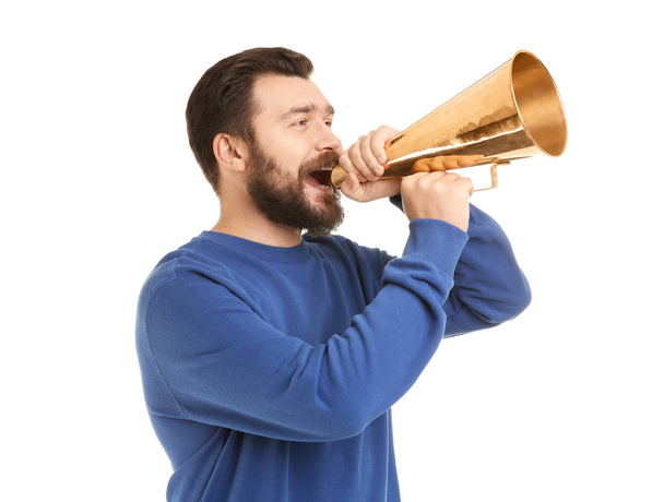 Young man shouting into megaphone on white background - Valokuva, kuva