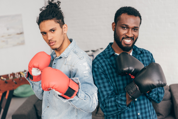 portrait of two young multicultural men in boxing gloves - Foto, Imagen