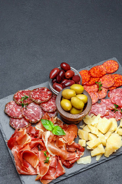 Meat and cheese plate with salami sausage, chorizo, parma and parmesan cheese - Foto, Imagem
