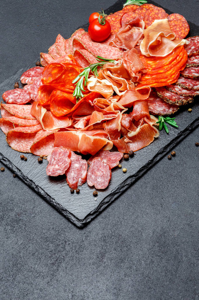Various types of Dried organic salami sausage and parma on concrete background - Foto, imagen