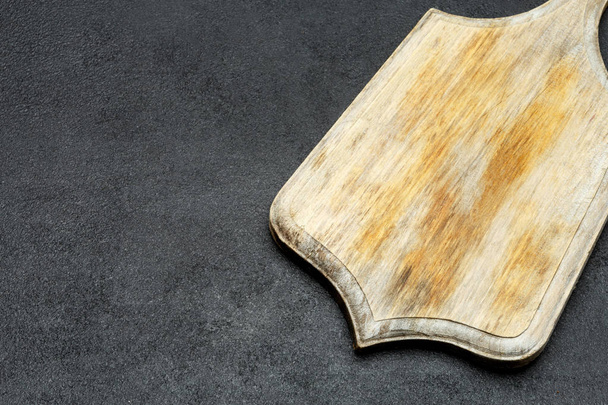decorative wooden serving or cutting board on concrete background - Fotó, kép
