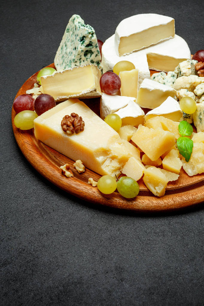 Cheese plate with Assorted cheeses Camembert, Brie, Parmesan blue cheese, goat - Photo, Image