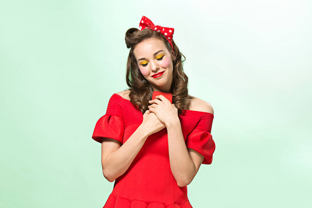 Beautiful young woman with pinup make-up and hairstyle. Studio shot on white background - Foto, immagini