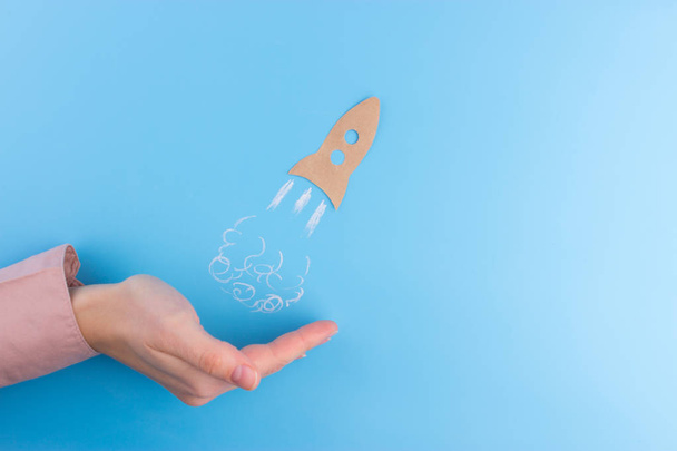rocket made from paper on blue background. business concept - Foto, Bild