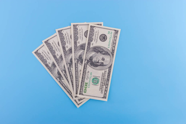 hundred dollar bills on the blue background - Фото, зображення