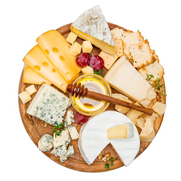 various types of cheese - brie, camembert, roquefort and cheddar on wooden board - Photo, Image