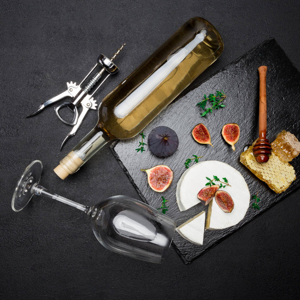 Camembert cheese and cut a slice on stone serving board - Фото, изображение