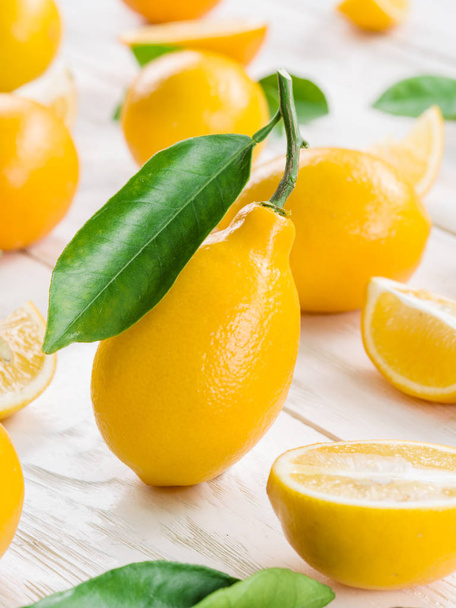 Ripe lemon fruits on the white wooden table. - Photo, image