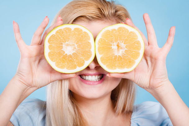 Girl covering her eyes with grapefruits - Zdjęcie, obraz