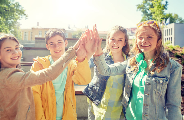 happy students or friends making high five - Фото, зображення