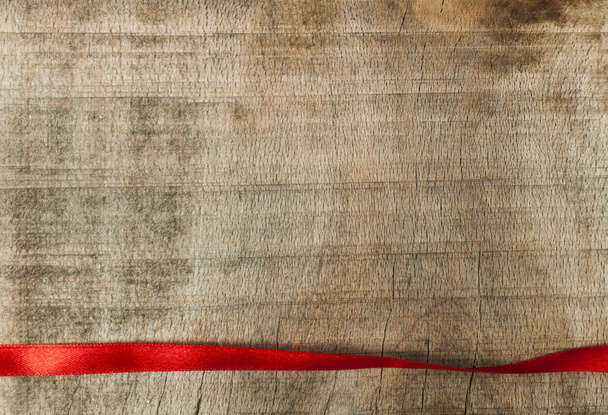 Red ribbon for gift wrap on wooden background - Foto, Imagem