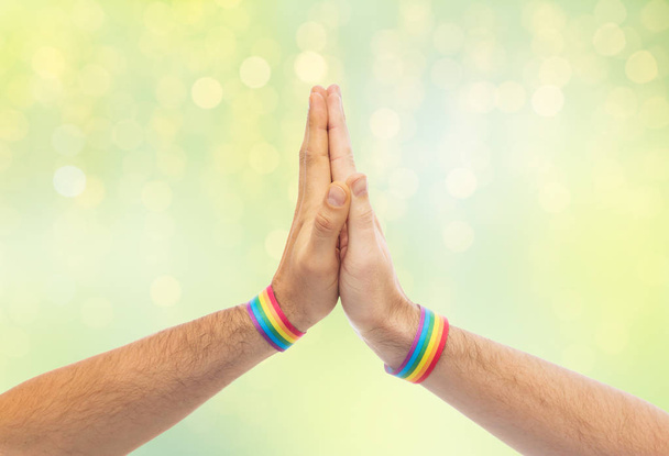 hands with gay pride wristbands make high five - Photo, Image