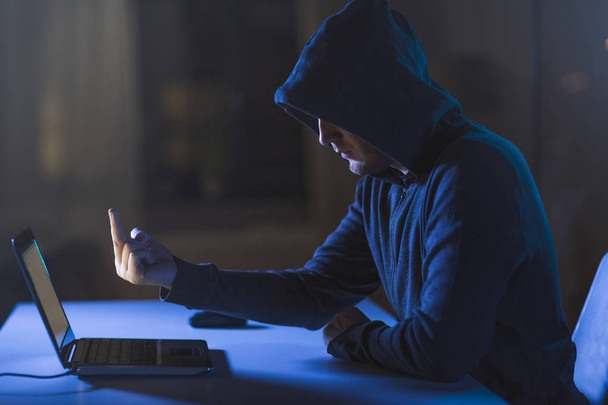 hacker showing middle finger to laptop - Foto, imagen