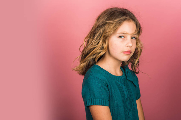 Charming cute little girl with curly hair on pink background. - Fotografie, Obrázek