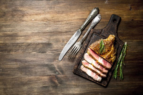 Beef grill with spices on a cutting Board. On a wooden table. - Foto, Bild