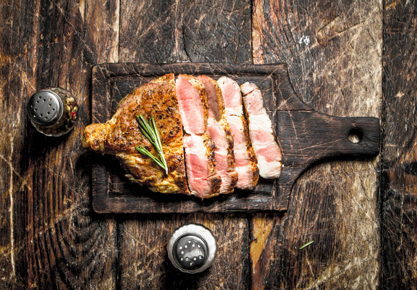 Grilled beef steak with spices. On wooden background. - Photo, Image