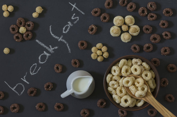 Bowl of Whole Grain Cereal rings with milk on a background of a  - Photo, Image