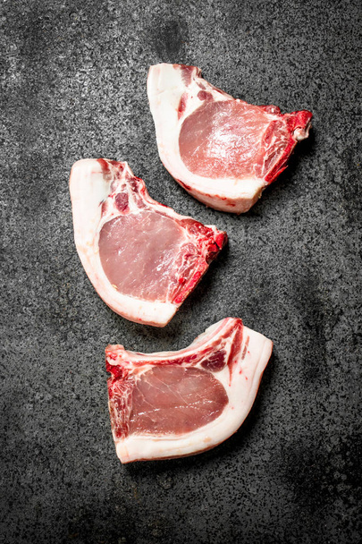 Raw pork steak. On rustic background - Φωτογραφία, εικόνα