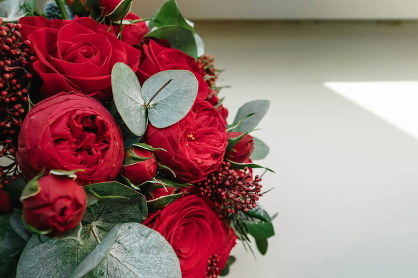A wedding bouquet of red roses lies on a white background. Wedding, holiday, marriage, family. - Fotografie, Obrázek
