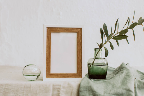 Mock up with olive branch in vase over linen tablecloth. Minimal eco concept - Fotografie, Obrázek