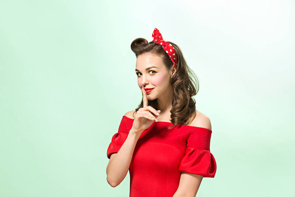 Beautiful young woman with pinup make-up and hairstyle. Studio shot on white background - Foto, afbeelding