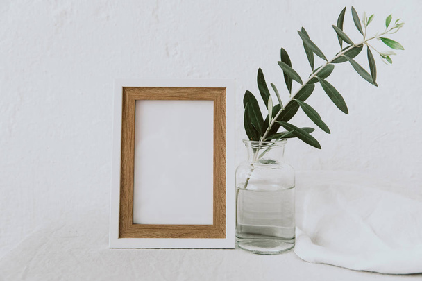 Mock up with olive branch in vase over linen tablecloth. Minimal eco concept - Fotoğraf, Görsel