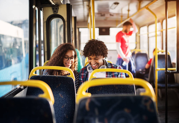 młody człowiek szczęśliwy i kobieta siedzi w autobusie - Zdjęcie, obraz