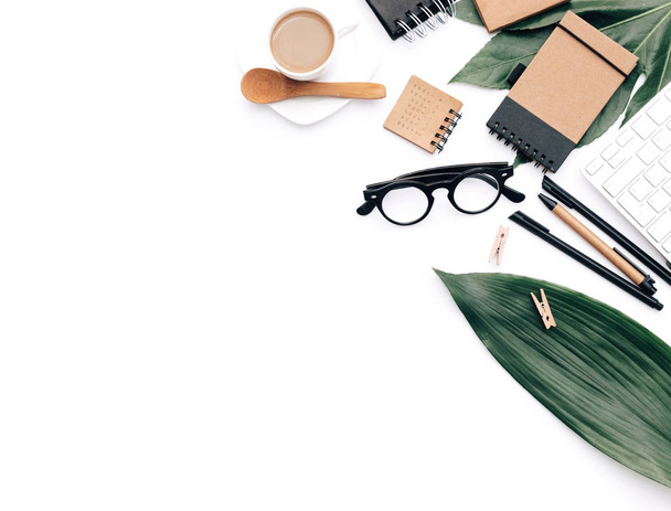 Minimal Office desk table with stationery set, supplies and palm leaves. Top view with copy space, creative flat lay. - Zdjęcie, obraz