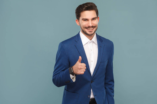 handsome businessman with mustache showing like sign at camera on light blue background, concept of richly and success business people  - Foto, immagini