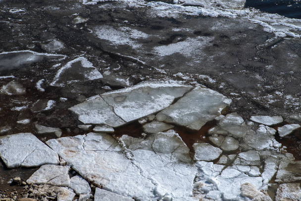 cracked ice on the river. early spring - 写真・画像