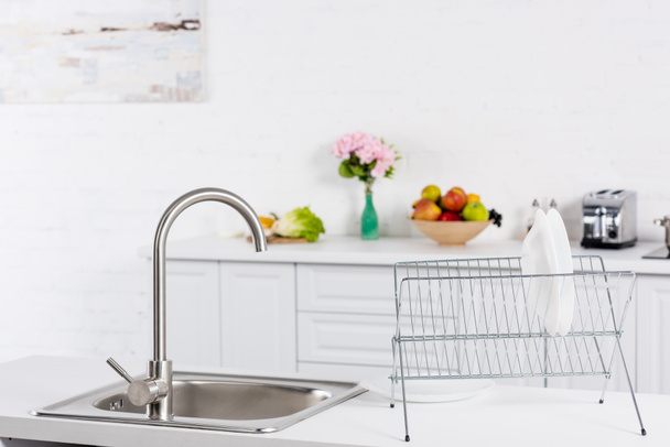 close up of sink and stand for dishes on kitchen - 写真・画像