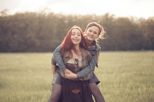Two young females having fun outdoors - Photo, Image