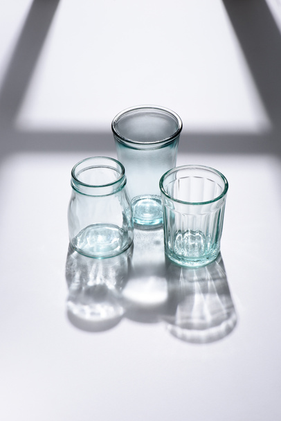 close up view of empty glassware on white surface - Fotó, kép