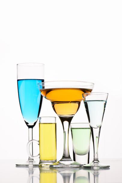 close up view of various alcohol cocktails in glasses on white backdrop - Fotoğraf, Görsel