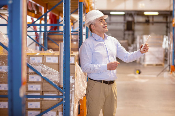 Smart skilled man working in the warehouse - Photo, Image