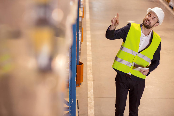 Positive logistic manager pointing at the box - 写真・画像