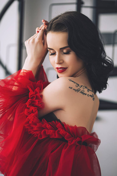 Stylish attractive woman with tattoo on her shoulder in the gorgeous long night dress, portrait of hot woman in stylish clothes with make up - Photo, image