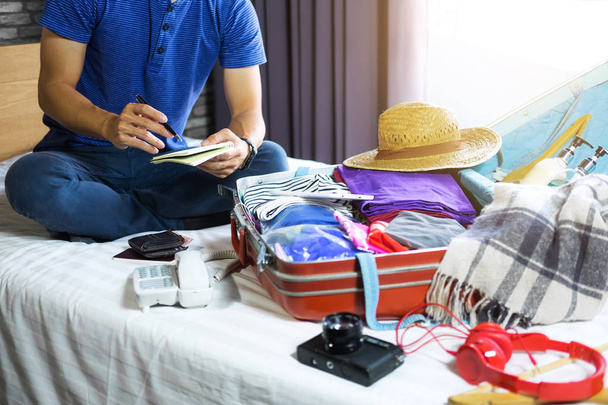 Travel and vacation concept, happiness young man packing a lot o - Foto, Imagem