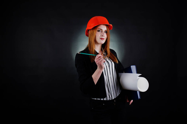 Engineer woman in orange protect helmet with construction paper  - Foto, Imagem
