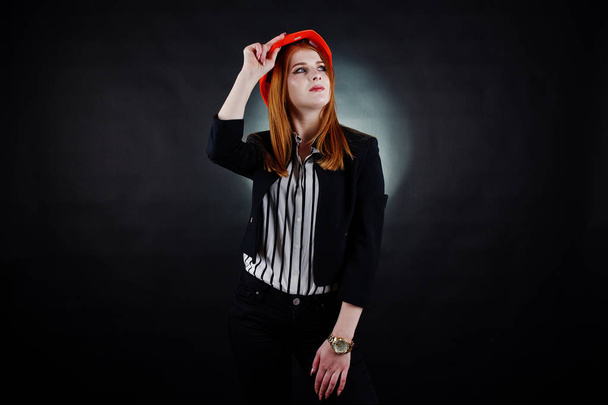 Engineer woman in orange protect helmet on studio black backgrou - Fotoğraf, Görsel